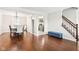 Open concept living room and dining area with hardwood floors and staircase access at 455 Meadowview Ln, Greenwood, IN 46142