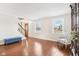 Bright living room featuring hardwood floors, large windows, and staircase access at 455 Meadowview Ln, Greenwood, IN 46142