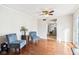 Hardwood floors with a view to the kitchen, two sitting chairs, and a side table at 455 Meadowview Ln, Greenwood, IN 46142
