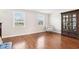 Bright living room featuring hardwood floors, ample natural light, and a decorative china cabinet at 455 Meadowview Ln, Greenwood, IN 46142