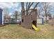 Wooden play structure with yellow slide and blue storage shed in backyard at 455 Meadowview Ln, Greenwood, IN 46142