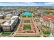 Aerial view of a city with well-manicured landscaping, buildings, roadways, and a pool at 502 Ironwood Dr, Carmel, IN 46033