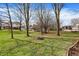 Lush backyard with mature trees and a fire pit, perfect for outdoor gatherings and relaxing evenings at 502 Ironwood Dr, Carmel, IN 46033