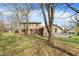 View of the home's backyard, highlighting a large deck and mature trees, perfect for outdoor entertaining and relaxation at 502 Ironwood Dr, Carmel, IN 46033