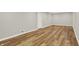 Unfinished basement with wood flooring, recessed lighting, and a white door at 502 Ironwood Dr, Carmel, IN 46033