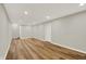 Spacious basement with wood flooring, recessed lighting, and a white door at 502 Ironwood Dr, Carmel, IN 46033