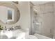 Modern bathroom featuring a marble vanity, round mirror, and glass-enclosed shower at 502 Ironwood Dr, Carmel, IN 46033