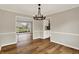 Dining room featuring hardwood floors, modern lighting, and neutral paint at 502 Ironwood Dr, Carmel, IN 46033