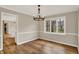 Dining room featuring hardwood floors, modern lighting, and neutral paint at 502 Ironwood Dr, Carmel, IN 46033