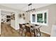 Charming dining area features a modern light fixture, a bay window, and seamless access to the open-concept kitchen at 502 Ironwood Dr, Carmel, IN 46033