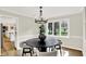 Bright dining room featuring a modern chandelier, table and natural light from a large window at 502 Ironwood Dr, Carmel, IN 46033