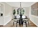 Elegant dining room with modern lighting, stylish furnishings, and a picturesque window view at 502 Ironwood Dr, Carmel, IN 46033