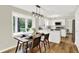 Dining area with modern light fixture and access to the kitchen at 502 Ironwood Dr, Carmel, IN 46033