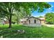 Two story home with a deck, brick chimney, and mature trees over a large back yard at 502 Ironwood Dr, Carmel, IN 46033