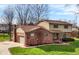 Charming two-story home with brick and vinyl siding, well-manicured lawn, and attached two-car garage at 502 Ironwood Dr, Carmel, IN 46033