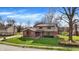 Two-story home with a well-maintained lawn, mature trees, and a brick and vinyl exterior at 502 Ironwood Dr, Carmel, IN 46033