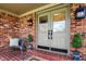 Inviting front porch with double doors, brick accents, stylish lighting, and comfortable seating at 502 Ironwood Dr, Carmel, IN 46033