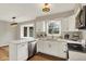 Bright kitchen featuring white cabinets, stainless steel appliances, quartz countertops, and a view into the yard at 502 Ironwood Dr, Carmel, IN 46033
