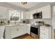 Modern kitchen features white cabinets, stainless steel appliances, and quartz countertops at 502 Ironwood Dr, Carmel, IN 46033