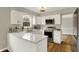Modern kitchen features white cabinets, stainless steel appliances, and a view of the outdoors at 502 Ironwood Dr, Carmel, IN 46033