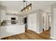 Open-concept kitchen with white cabinets, stainless steel appliances, and an island at 502 Ironwood Dr, Carmel, IN 46033
