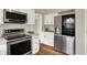 Modern kitchen featuring stainless steel appliances, sleek cabinets, and hardwood flooring at 502 Ironwood Dr, Carmel, IN 46033