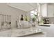 Bright kitchen with stainless steel appliances, white cabinets, marble countertops, and modern fixtures at 502 Ironwood Dr, Carmel, IN 46033