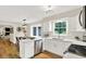 Bright kitchen features white cabinetry, stainless steel appliances, and a breakfast bar overlooking the dining area at 502 Ironwood Dr, Carmel, IN 46033
