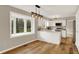 Bright and open kitchen with white cabinets, hardwood floors, stainless steel appliances and natural light at 502 Ironwood Dr, Carmel, IN 46033