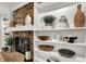 Close up of a living room fireplace with detailed shelving and decor accents at 502 Ironwood Dr, Carmel, IN 46033