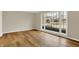 Bright living room with hardwood floors and large windows providing ample natural light and neighborhood views at 502 Ironwood Dr, Carmel, IN 46033