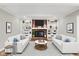Inviting living room with a brick fireplace, built-in shelving, and plush sofas at 502 Ironwood Dr, Carmel, IN 46033