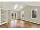 Living room featuring vaulted ceilings, skylights, and French doors to a backyard at 502 Ironwood Dr, Carmel, IN 46033