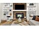 Cozy living room showcasing a brick fireplace with built-in shelving, perfect for display and entertainment at 502 Ironwood Dr, Carmel, IN 46033