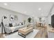 Living room featuring a neutral-toned couch, wood floors, recessed lighting, and an open floor plan at 502 Ironwood Dr, Carmel, IN 46033