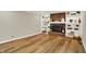 Spacious living room featuring a brick fireplace with built-in shelving and hardwood floors at 502 Ironwood Dr, Carmel, IN 46033