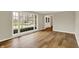 Well-lit living room featuring hardwood floors, a large window, and neutral paint at 502 Ironwood Dr, Carmel, IN 46033