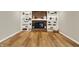 Bright living room featuring brick fireplace, custom shelving, and hardwood floors at 502 Ironwood Dr, Carmel, IN 46033