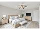 Well-appointed primary bedroom suite features neutral decor, ceiling fan, and walk in closet at 502 Ironwood Dr, Carmel, IN 46033