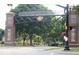 Carmel Arts & Design District entrance featuring brick pillars, hanging flower baskets, and well-maintained sidewalks at 502 Ironwood Dr, Carmel, IN 46033
