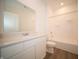 Bathroom with a white vanity, large mirror, and a combined tub and shower at 5145 Cartland Dr, Indianapolis, IN 46239