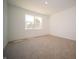 This bedroom features plush carpet, a bright window, and neutral walls at 5145 Cartland Dr, Indianapolis, IN 46239