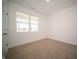 Carpeted bedroom featuring a large window providing ample natural light at 5145 Cartland Dr, Indianapolis, IN 46239