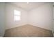 A carpeted bedroom featuring a window, clean white walls and an electrical outlet at 5145 Cartland Dr, Indianapolis, IN 46239