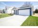 A single-Gathering home featuring a two-car garage, long driveway and landscaped front yard at 5145 Cartland Dr, Indianapolis, IN 46239
