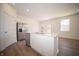 Modern kitchen featuring an island, stainless steel refrigerator and appliances and white cabinets at 5145 Cartland Dr, Indianapolis, IN 46239
