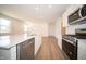 Gourmet kitchen featuring stainless steel appliances, center island, and hardwood floors at 5145 Cartland Dr, Indianapolis, IN 46239