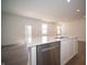 Modern kitchen with stainless steel dishwasher and a large island with bar seating at 5145 Cartland Dr, Indianapolis, IN 46239