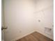 Bright laundry room boasts sleek wood-look flooring and convenient washer/dryer hookups at 5145 Cartland Dr, Indianapolis, IN 46239