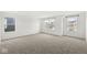 Spacious bedroom with plush carpeting, white walls, and multiple windows at 5421 Landing Place Ln, Noblesville, IN 46062